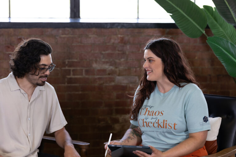 Business consultant smiling during a systems strategy session focused on SOPs for small business efficiency.