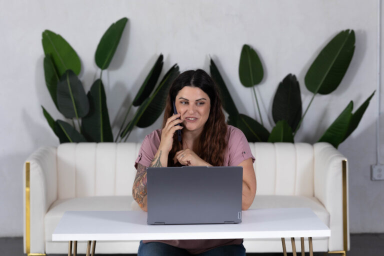 Business owner managing tasks on laptop while receiving operations support to streamline workflow