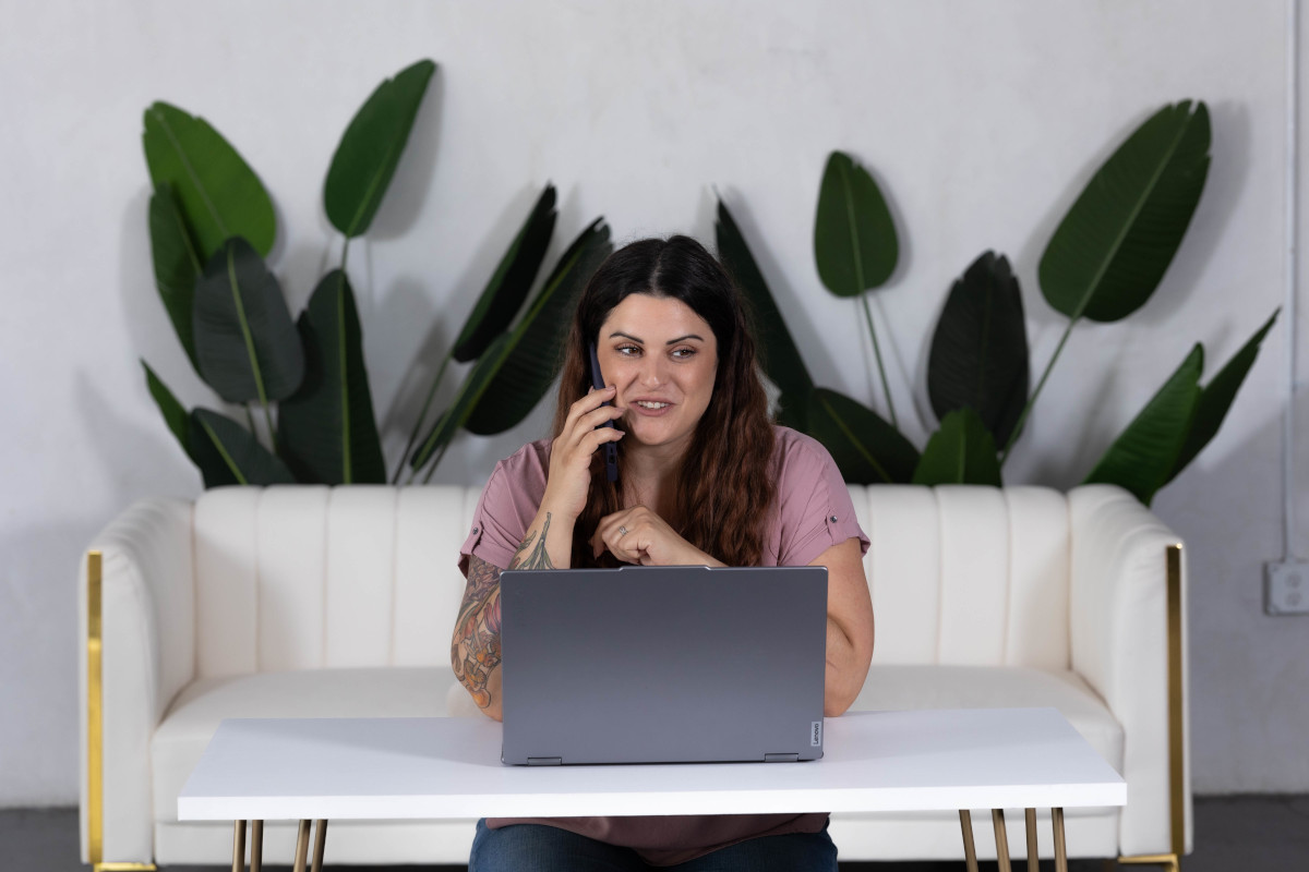 Business owner managing tasks on laptop while receiving operations support to streamline workflow